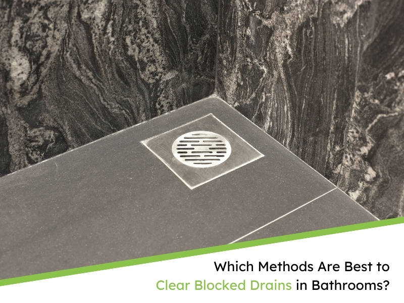 Shower floor with a square metal drain cover in a bathroom with dark marbled tiles, highlighting the need to clear blocked drains in bathrooms.