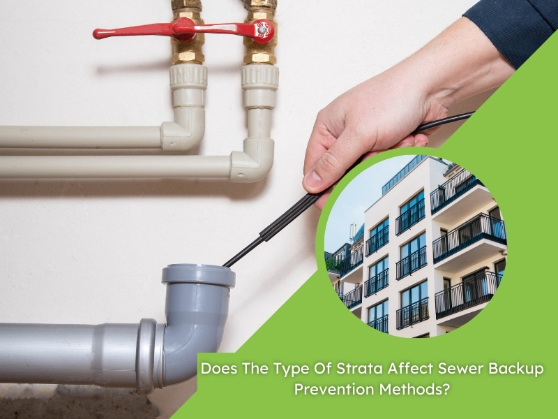 Hand using a plumbing tool for sewer backup prevention in a strata building drainage system.