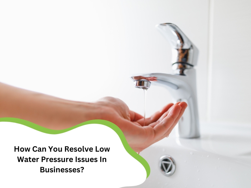 A hand holding water dripping from a tap. Learn how to fix low water pressure in your business.