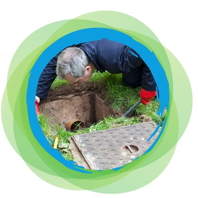A plumber inspecting a hole in the ground, assessing and fixing issues related to blocked drains in Hassall Grove
