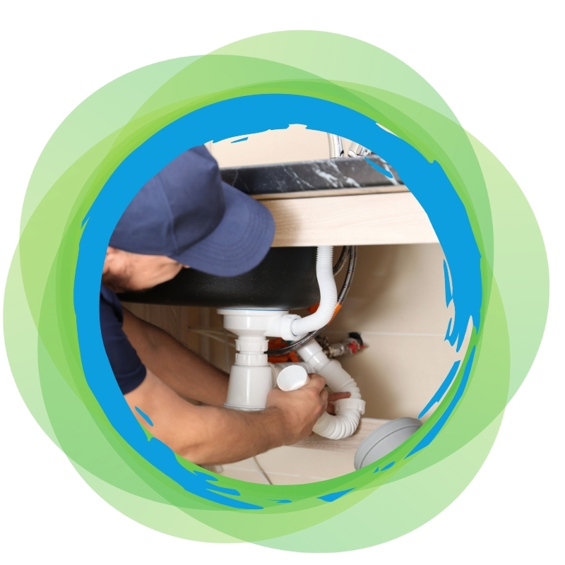 Kitchen plumbers fixing sink pipes under a countertop, ensuring proper drainage and leak-free plumbing solutions for homeowners.