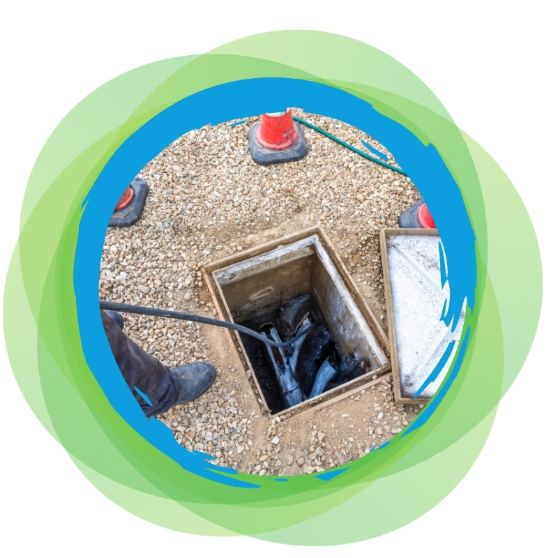 Sewer Blocked Drain being cleared with a high-pressure hose by a technician in an access pit.