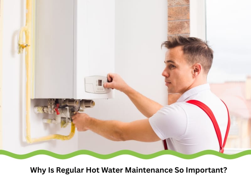 Technician performing hot water maintenance on modern heating unit.