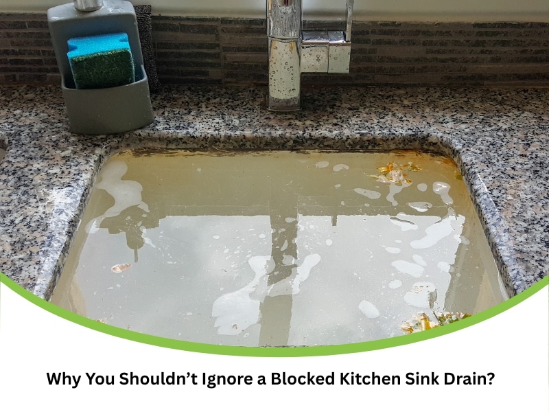 Kitchen sink blocked drain with standing dirty water and food waste floating in a granite basin