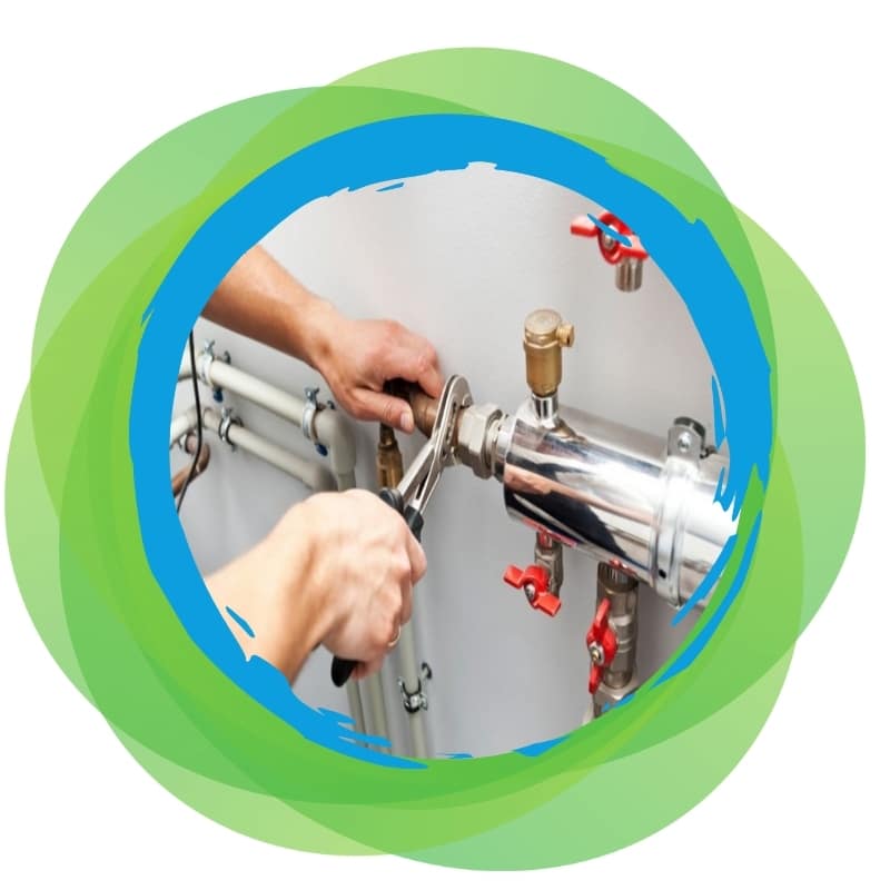 Plumber in Waterfall tightening brass pipe fitting with wrench at a workbench.
